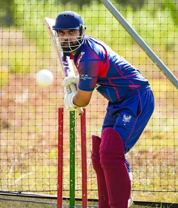 player wearing blue and red color cricket uniform