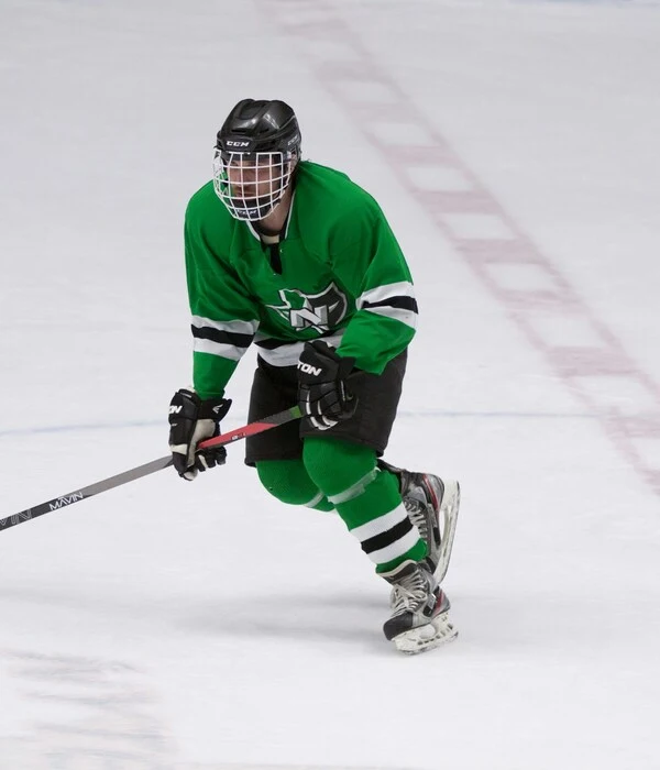 player wearing ice hockey uniform light background desigend by Humex Apparel