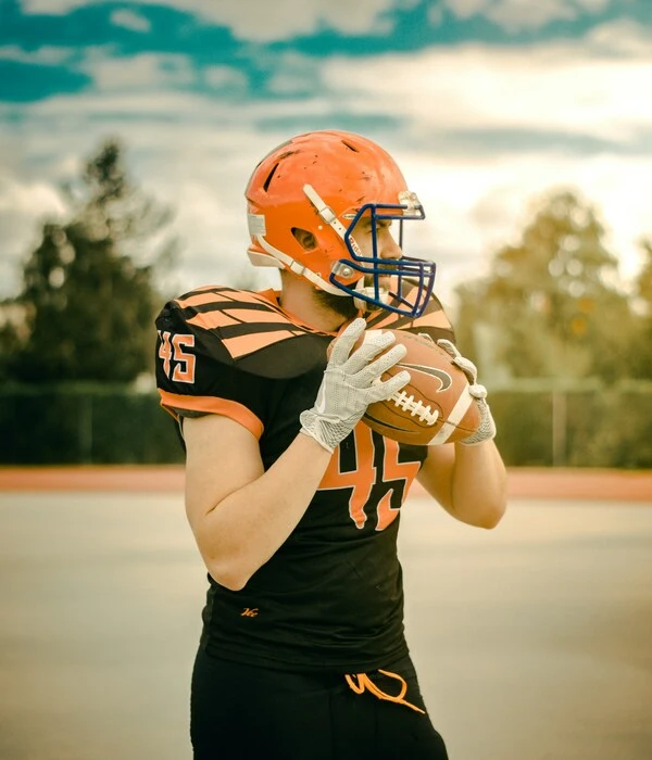 player wearing black and red american football uniform designed by Humex Apparel