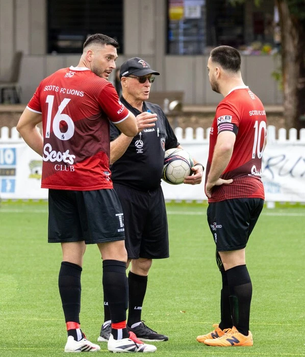 soccer players wearing red and black color uniform designed by Humex Apparel